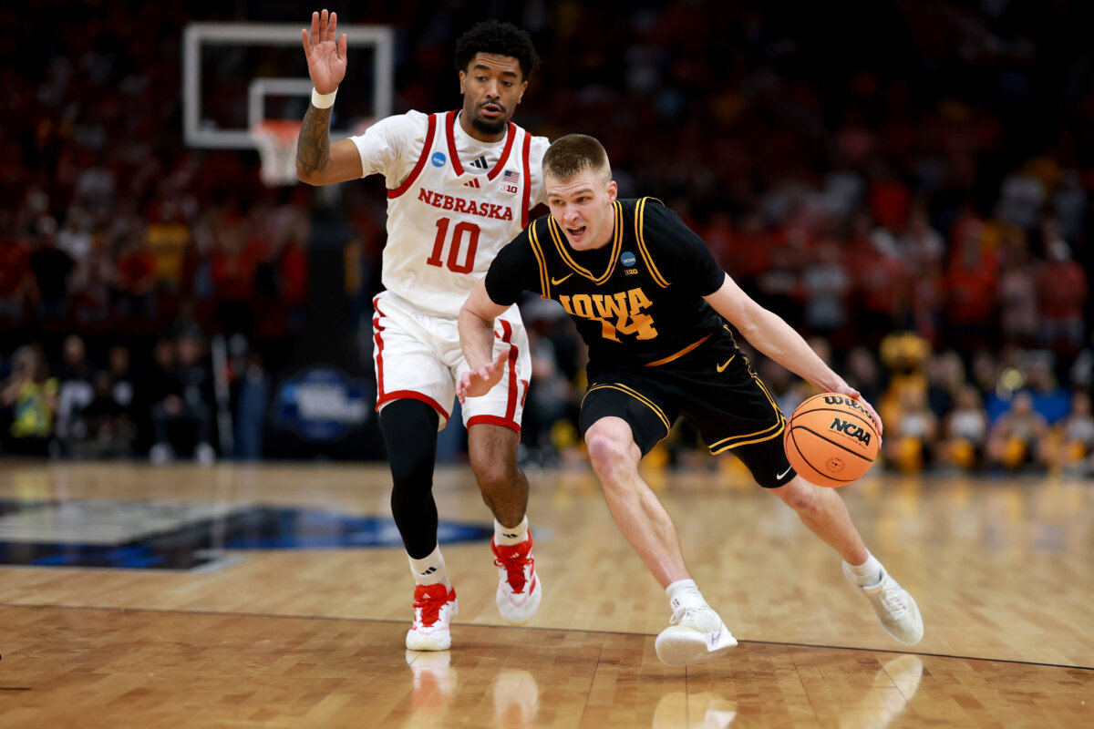 Bennett Stirtz (14) of the Iowa Hawkeyes dribbles against Jamarques Lawrence (10) of the Nebraska Cornhuskers during the first half in the Sweet Sixteen of the 2026 NCAA Men's Basketball Tournament at Toyota Center in Houston on March 26, 2026. (Kenneth Richmond/Getty Images)