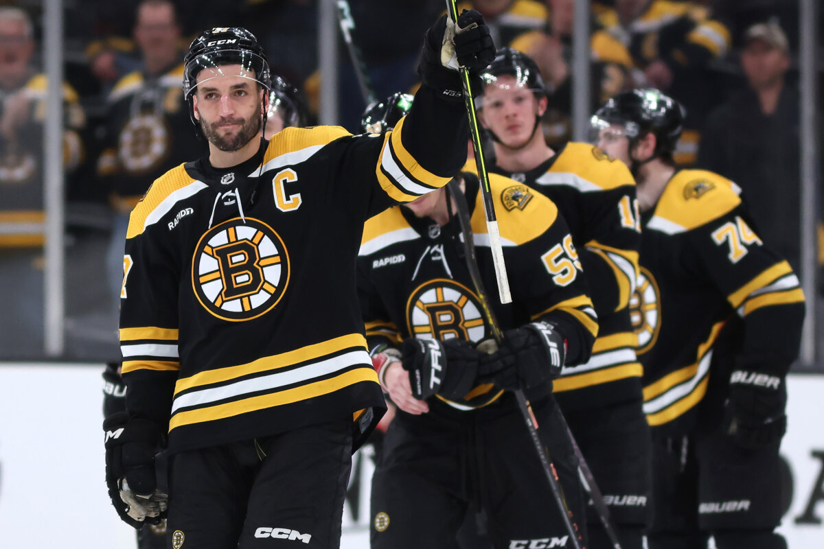 Patrice Bergeron (L) of the Bruins waves to the fans after the Florida Panthers defeated Boston 4-3 in overtime of Game 7 in the first round of the 2023 Stanley Cup Playoffs at TD Garden in Boston on April 30, 2023. (Maddie Meyer/Getty Images)