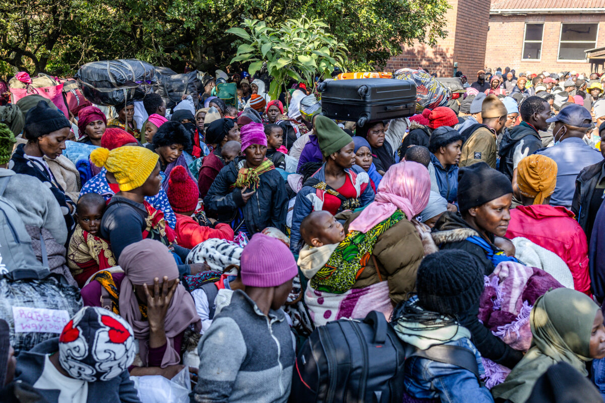 Displaced Malawian nationals prepare to board a bus at an abandoned municipality building on Mayor's Walk in Pietermaritzburg, South Africa, on June 23, 2026, after fleeing their homes amid fears of xenophobic attacks. (Rajesh Jantilal/AFP via Getty Images)