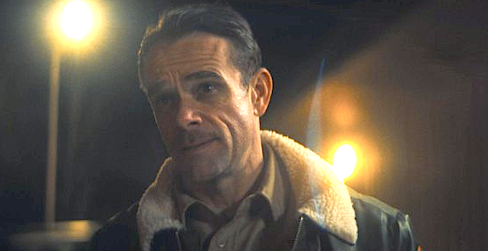 Caucasian man stands under street lamps in Gangland