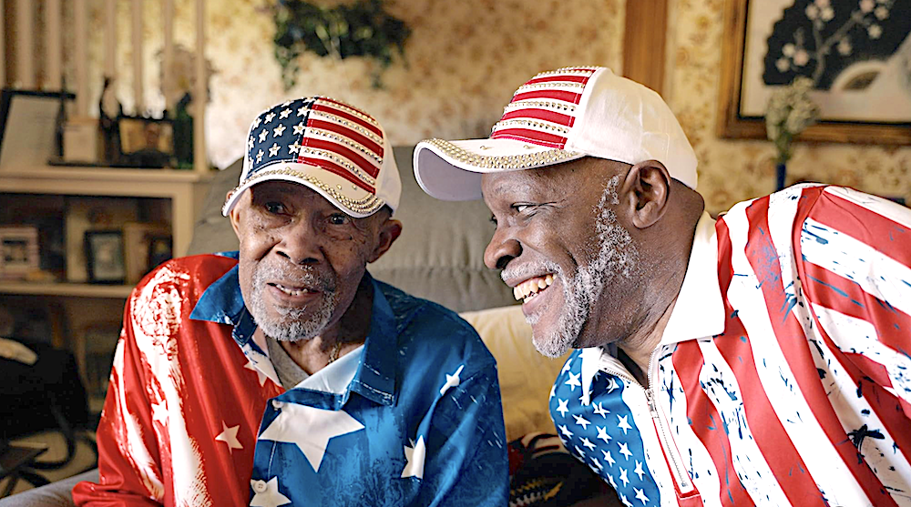 two older african american men wearing American flag patterned shirts and caps in Flag Day