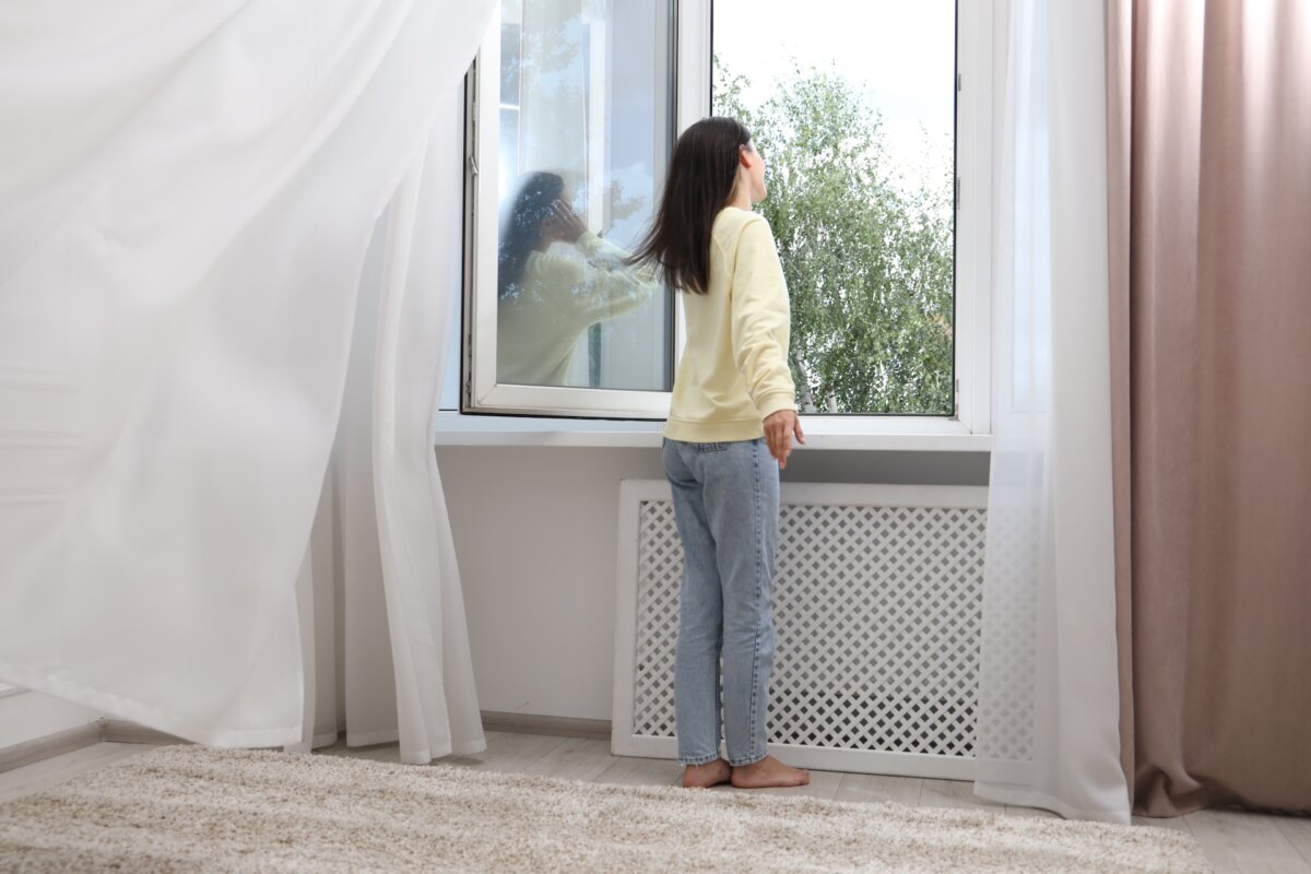 Once the evening cools off, start by opening windows on opposite sides of the house. Cross-ventilation is your best friend. You want the air moving through the house, not just sitting there thinking about it. (New Africa/Shutterstock)