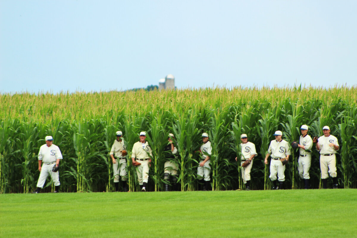 The Ghost Players wearing 1919 Chicago White Sox uniforms emerge from the same cornfield depicted in the 1989 movie “Field of Dreams.” (Scott K Baker/Shutterstock)