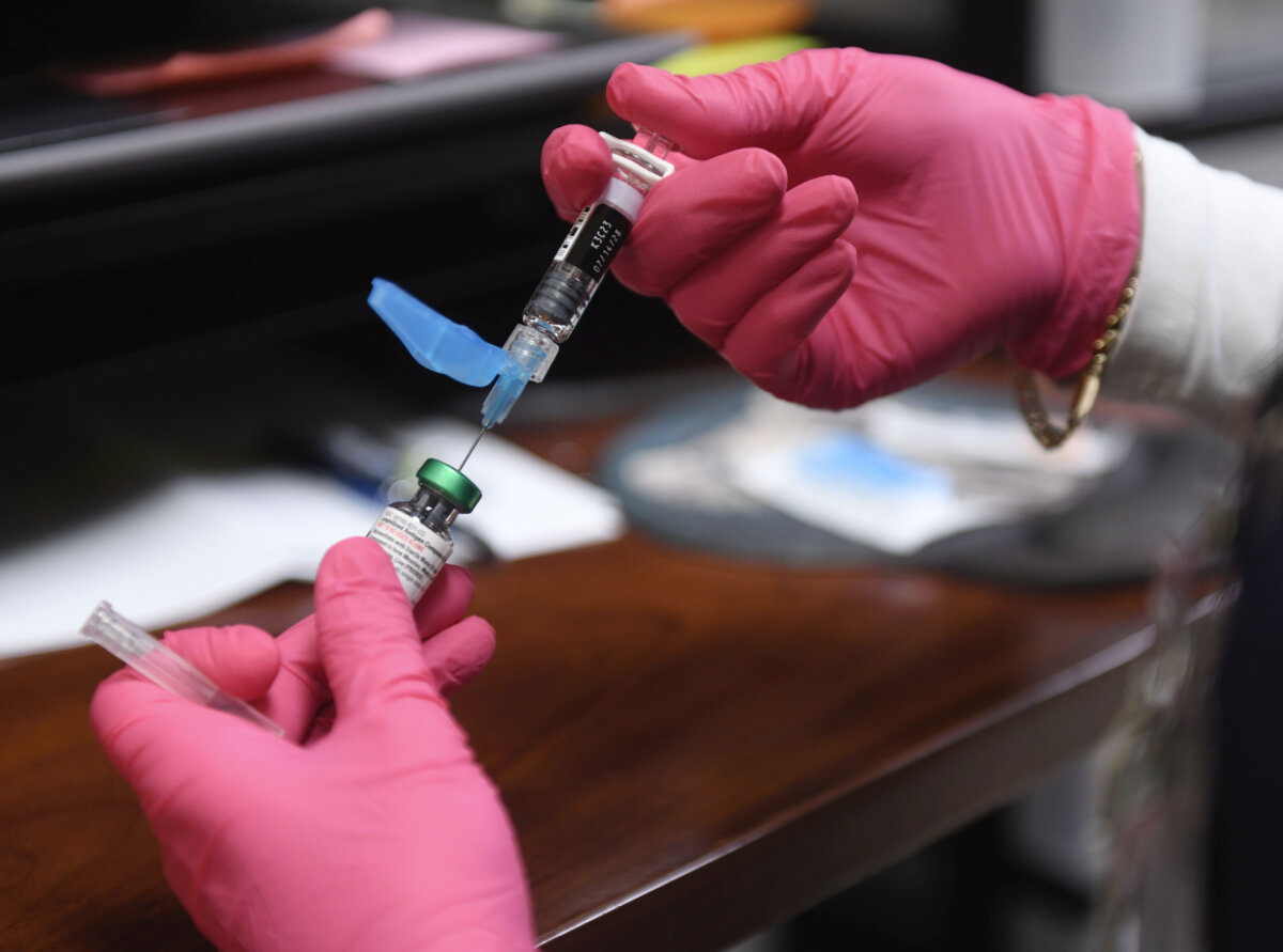 A health-care professional prepares a measles, mumps and rubella (MMR) vaccine at the Andrews County Health Department in Andrews, Texas, on April 8, 2025. (AP Photo/Annie Rice)