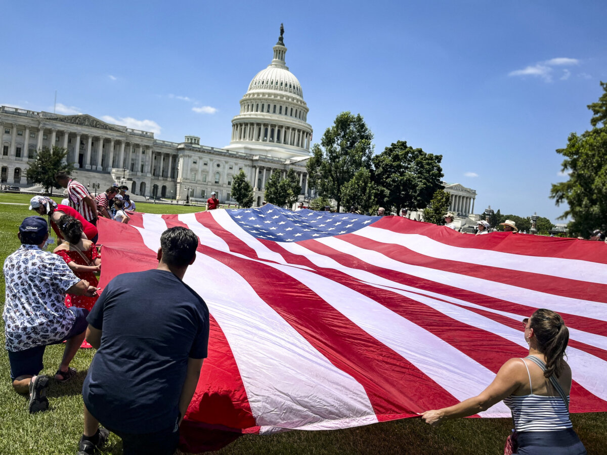 People deploy a large US flag near the US Capitol as part of the “Salute to America” Independence Day celebration on the National Mall in Washington, on July 4, 2026. The nation is marking the 250th anniversary of the United States Declaration of Indpendence. (Eva Hambach / AFP via Getty Images)