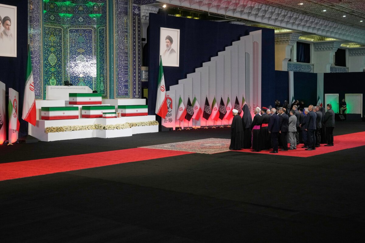Iranian religious leaders and other mourners pay their respects before the coffins of slain Iranian leader Ayatollah Ali Khamenei and members of his family during a viewing ceremony ahead of the funeral ceremonies at the Imam Khomeini Mosalla Grand Mosque in Tehran, Iran, on July 3, 2026. (Vahid Salemi/AP)
