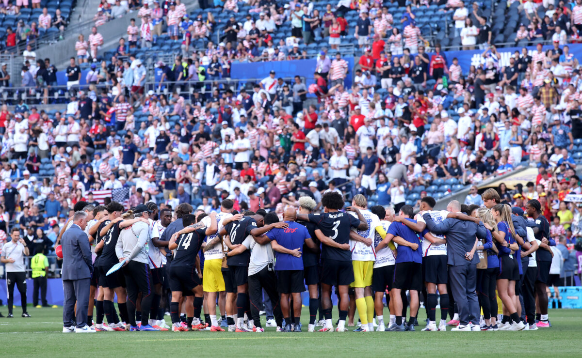 U.S. players and team officials huddle after the team's 1–4 loss during the FIFA World Cup 2026 Round of 16 match between USA and Belgium at Seattle Stadium in Seattle on July 6, 2026. (Alex Grimm/Getty Images)