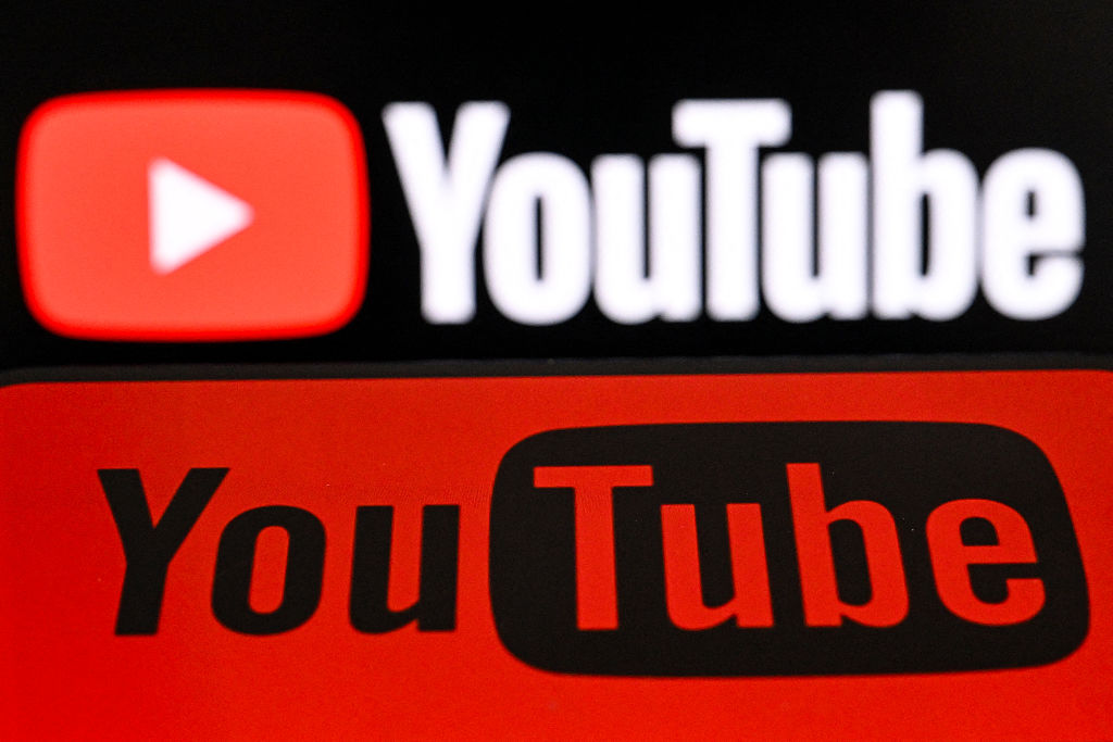 The U.S. video platform Youtube's logo is displayed on a smartphone and a laptop screen in Frankfurt am Main, western Germany, on May 19, 2026. (Kirill Kudryavtsev/AFP via Getty Images)