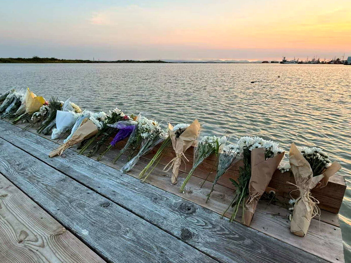 Flowers are seen placed alongside the Imperial Landing Dock in Richmond, B.C., in this handout photo, on June 5, 2026, to pay tribute to six people who are presumed drowned following the tragic capsizing, on June 28, 2026, of a commercial charter fishing boat in the Strait of Georgia. (The Canadian Press/Handout—Caryn Zhang)