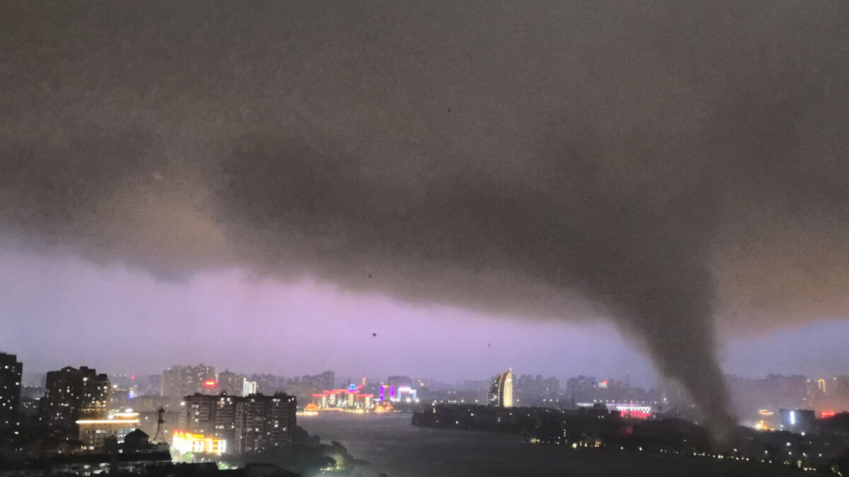 A tornado moves through an area amid lightning and strong winds, in Ezhou, Hubei province, China, July 6, 2026, in this screen grab obtained from social media video. (Social Media via Reuters)