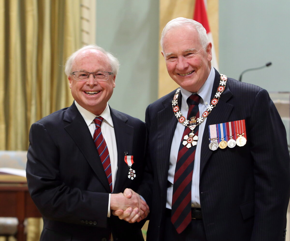 Eddie Goldenberg of Ottawa (L) shakes hands with Governor General David Johnston as he was invested as Member to the Order of Canada at a ceremony at Rideau Hall the official residence of the Governor General in Ottawa, on Nov. 21, 2014. (The Canadian Press/Fred Chartrand)