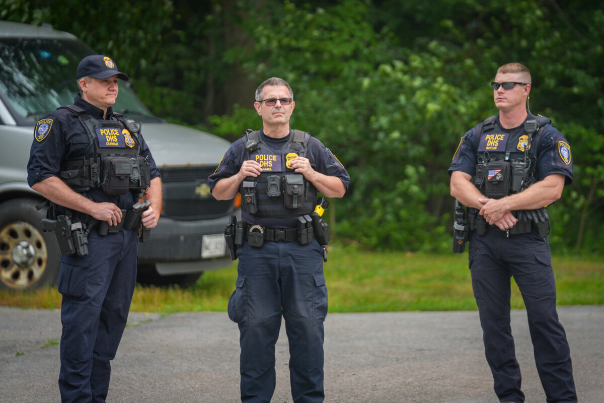 Department of Homeland Security (DHS) officers stand guard outside of a federal immigration office after a man was fatally shot by U.S. Immigration and Customs Enforcement (ICE) agents, in Scarborough, Maine, on July 14, 2026. (Ryan Murphy/Getty Images)
