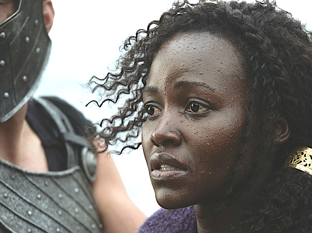 woman being escorted by soldier in The Odyssey