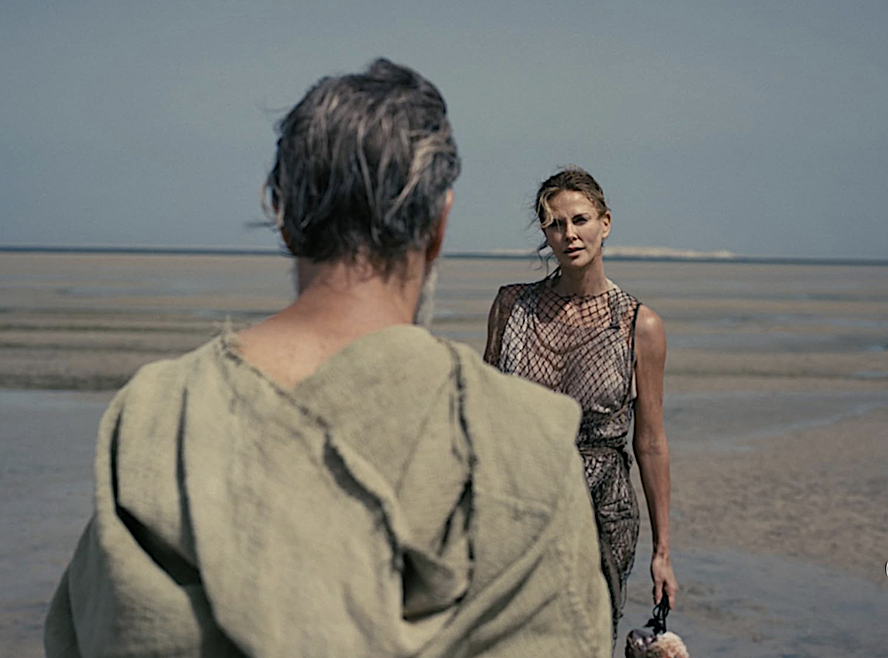 man and woman on the beach in The Odyssey