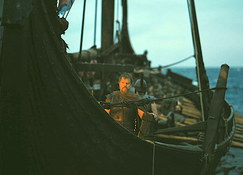 Man stands in the middle of a Greek ship in The Odyssey