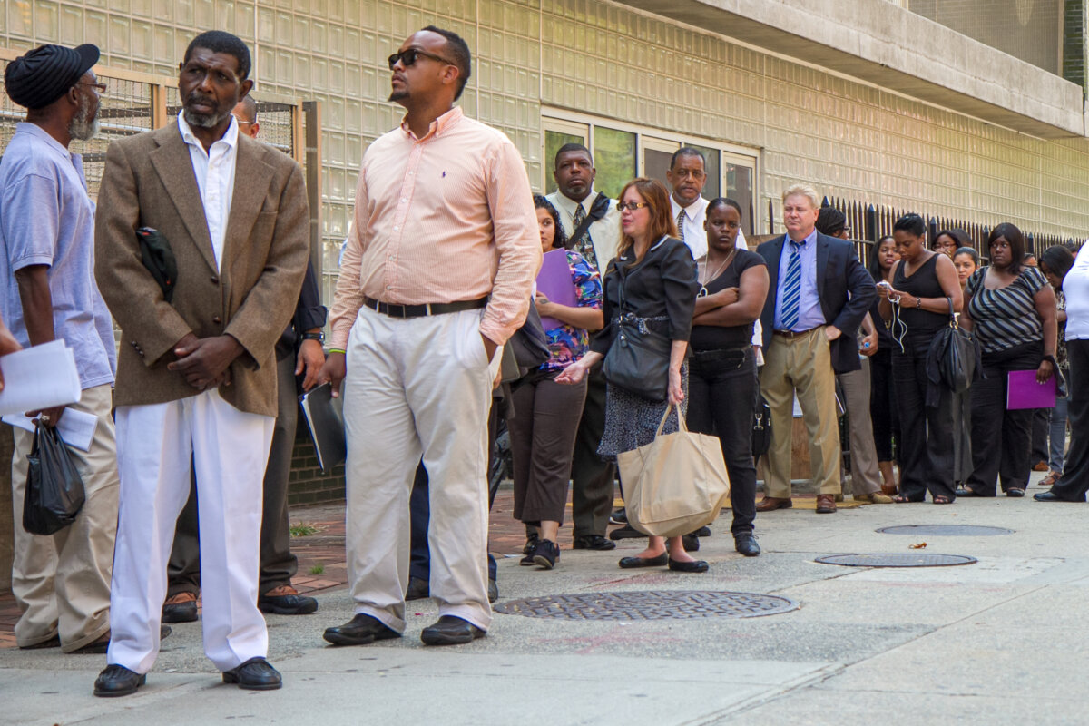 People queue in line at the James Weldon Johnson Community Center where they are holding a job fair in Harlem, New York, on Aug. 15, 2012. (Benjamin Chasteen/The Epoch Times)