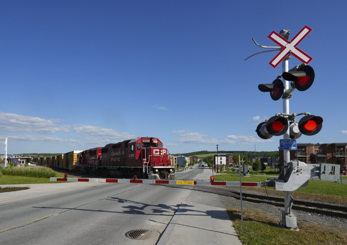 A train passes through Lac Megantic, Que. on June 22, 2023. (The Canadian Press/Christinne Muschi)