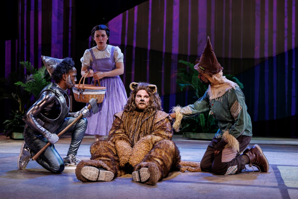 (L–R) David Omari as Tin Man, Nora Wragg as Dorothy Gale, Jake Elkins as Cowardly Lion, and Ben Woods as Scarecrow in "The Wizard of Oz." (Jennifer Heim)