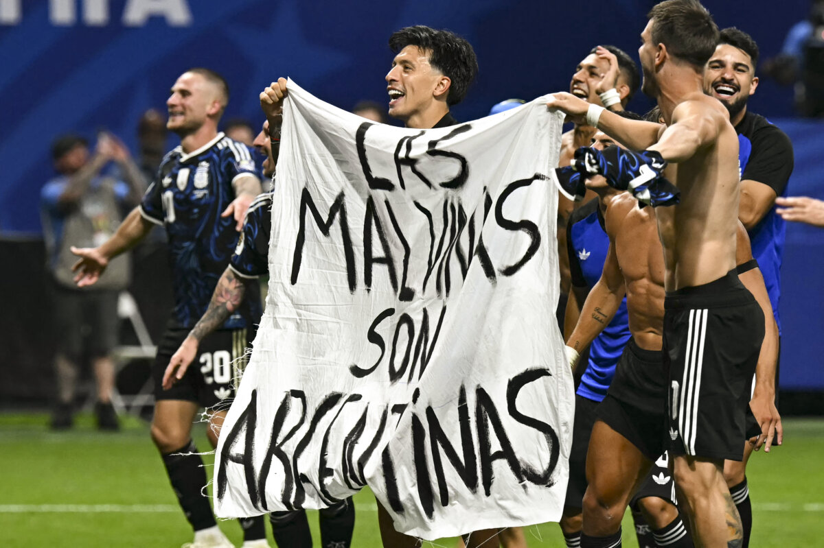 Argentina's players hold a banner reading "The Malvinas (Falkland Islands) belong to Argentina," after winning the 2026 World Cup football tournament semi-final match between England and Argentina at the Atlanta Stadium in Atlanta on July 15, 2026. (Paul Ellis/ AFP via Getty Images)