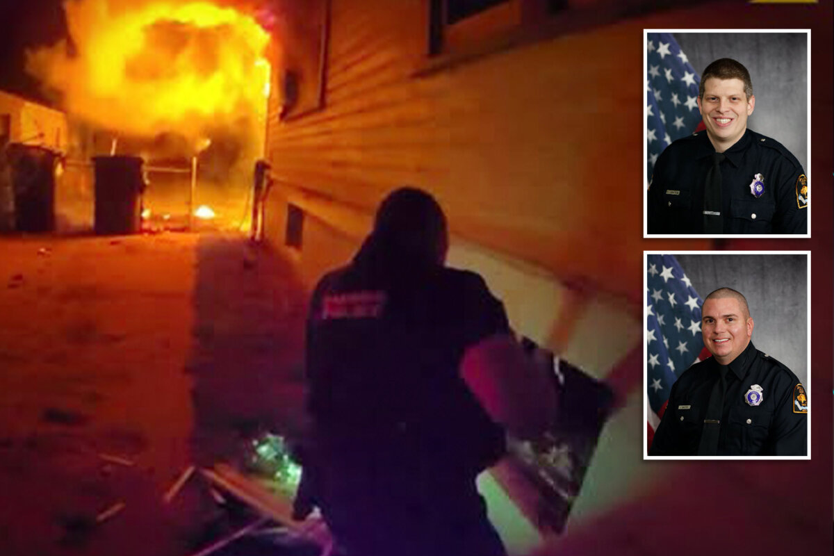 Omaha Police Officers kick in a window to rescue a 4-year-old boy trapped in the basement of a house that had caught fire. (Omaha Police Department)