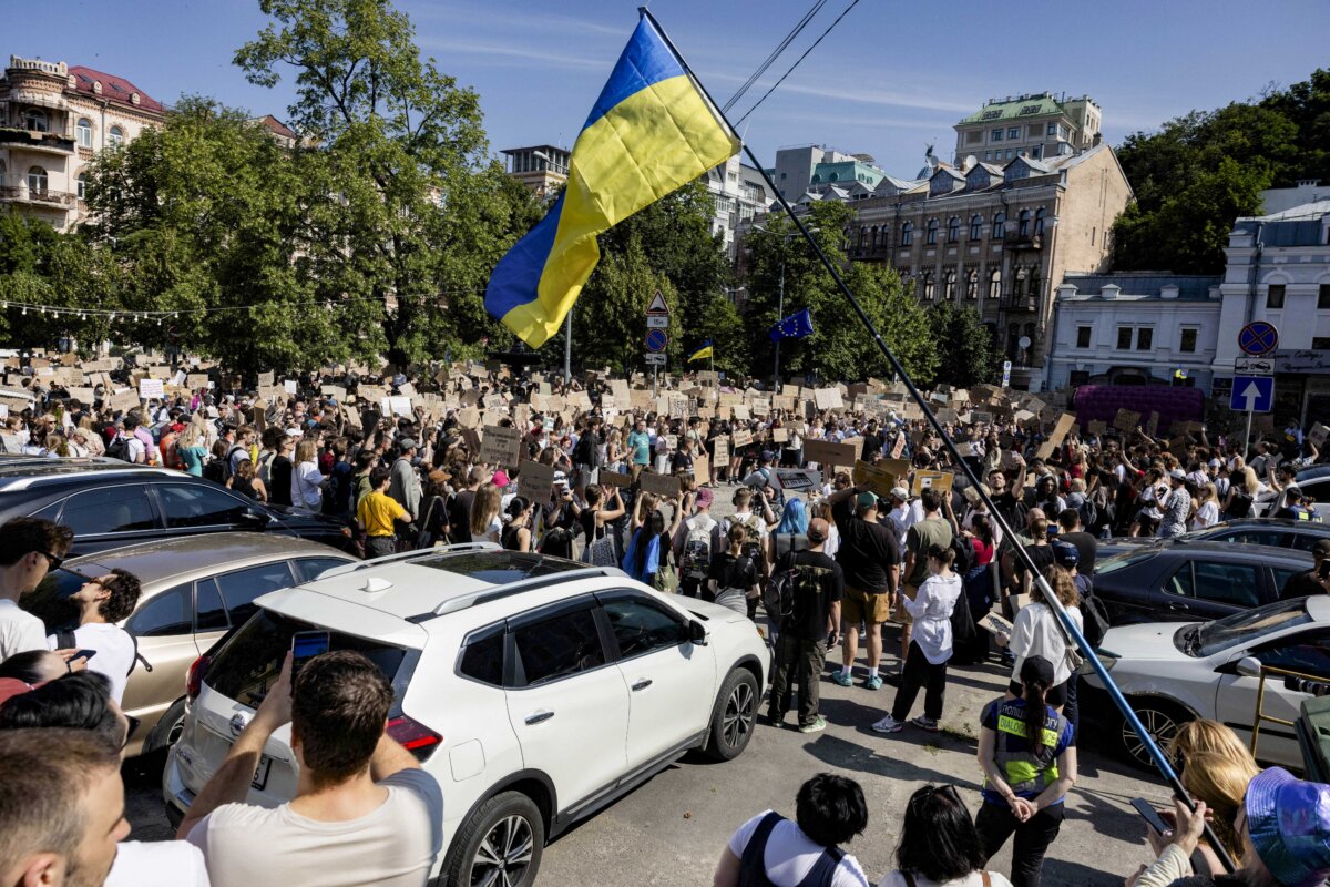 Protesters chant slogans and wave a Ukranian national flag as they take part in a demonstration against Ukraine's President Volodymyr Zelensky's decision to dismiss Ukraine's Defence Minister Mykhailo Fedorov, in Kyiv on July 16, 2026.(Tetiana Dzhafarova / AFP via Getty Images)
