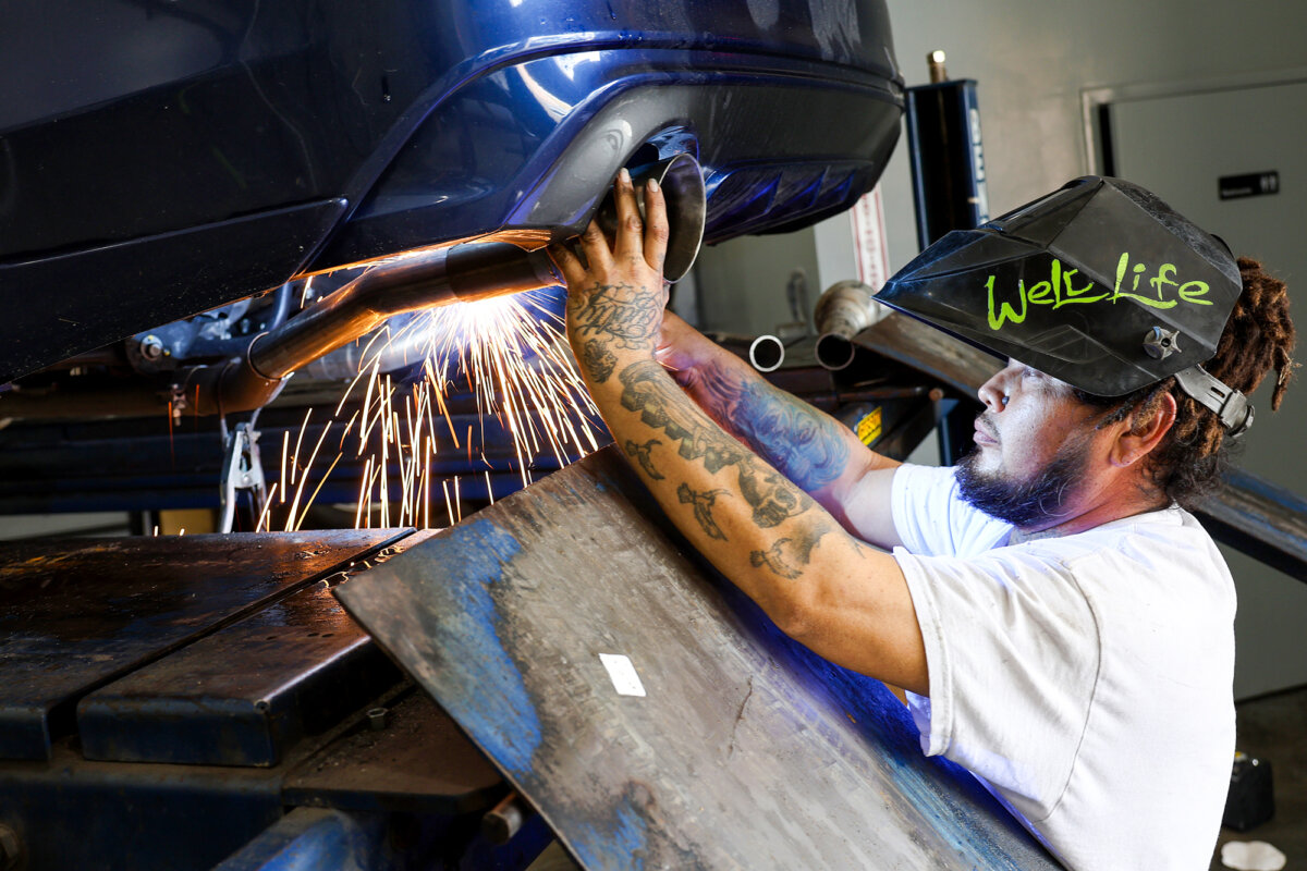 A mechanic installs a catalytic converter at Johnny Franklin's Muffler in San Rafael, Calif., on July 11, 2022. (Justin Sullivan/Getty Images)