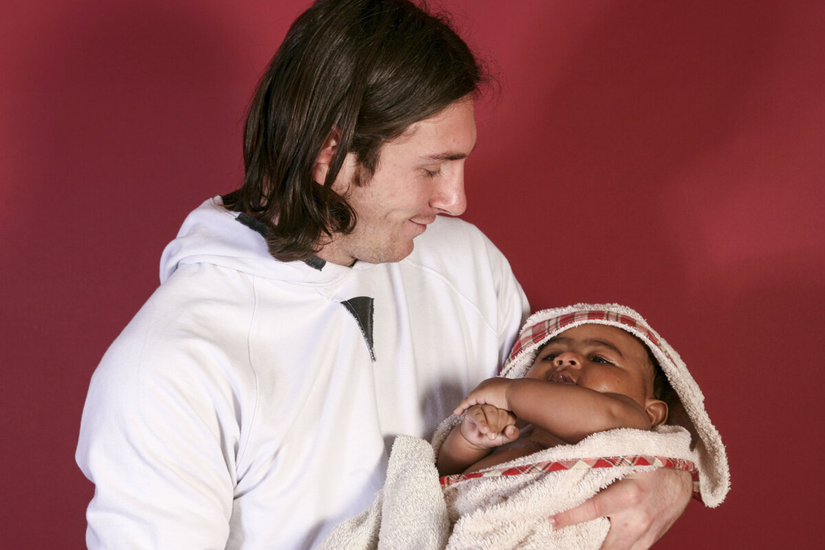 20-year-old soccer star Lionel Messi cradles Lamine Yamal, who was merely six months old at the time during a photo session in Sept. 2007 in the dressing room of the Camp Nou stadium in Barcelona, Spain. (Joan Monfort/AP Photo)