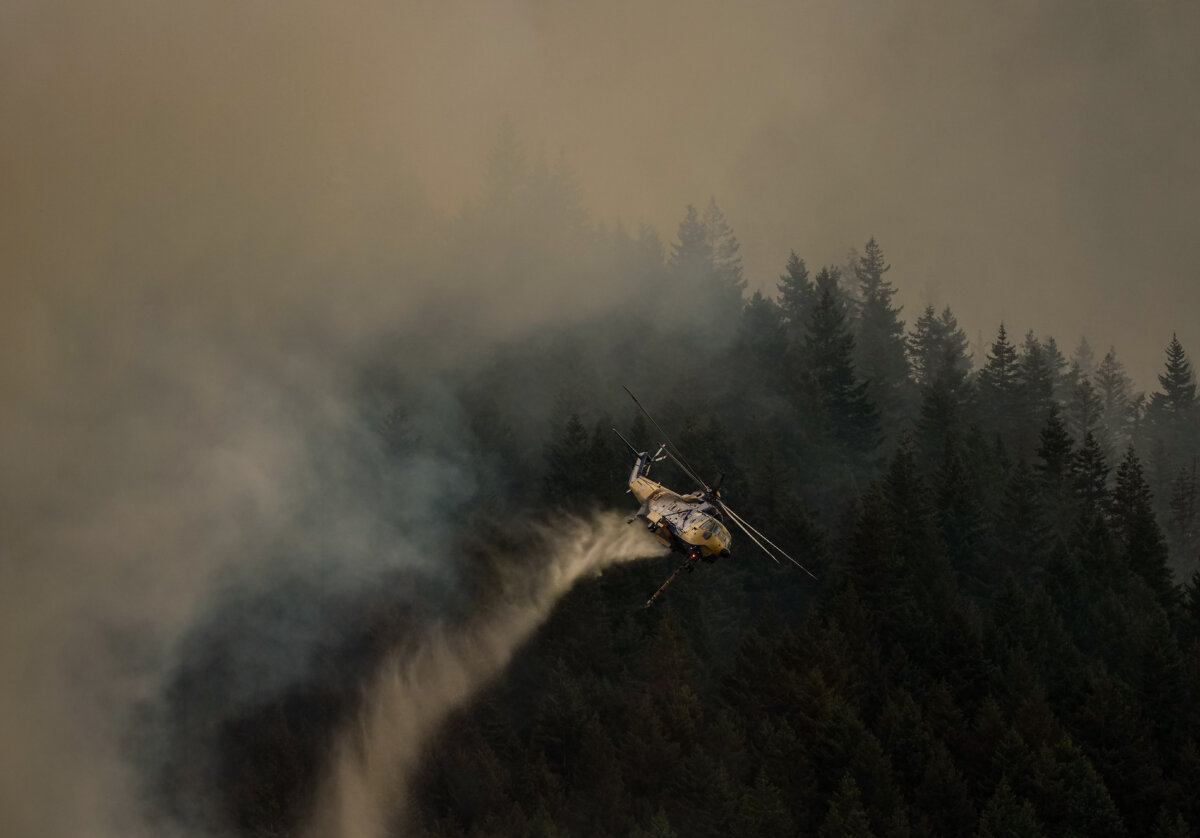 A helicopter drops water while fighting the Brunswick Creek wildfire in Boston Bar, B.C., on July 9, 2026. (The Canadian Press/Darryl Dyck)