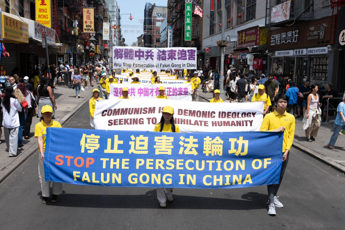 Falun Gong practitioners march during a parade calling for the end of the Chinese Communist Party’s 27 years of ongoing persecution against the spiritual practice, in New York City on July 19, 2026. (Larry Dye/The Epoch Times)