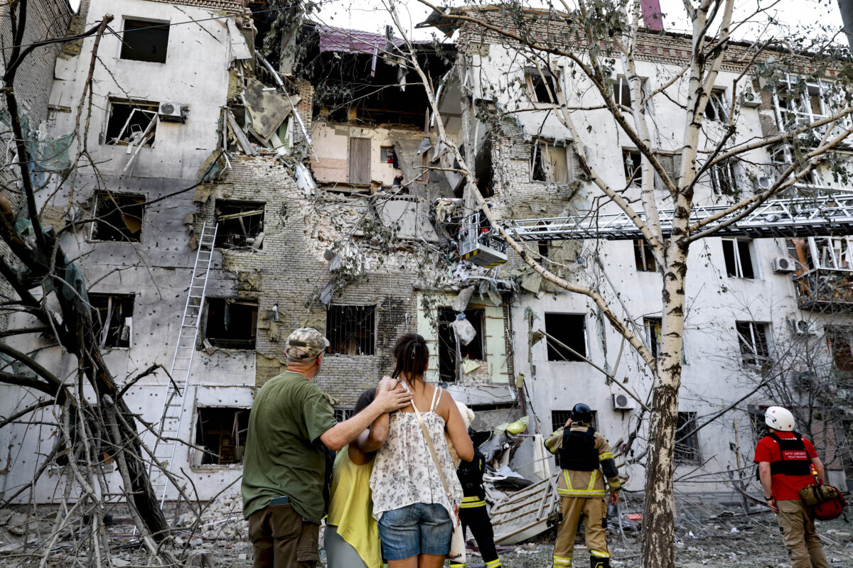Residents look at their ruined home following a Russian air guided bomb strike in Zaporizhzhia, Ukraine, on July 19, 2026. (Kateryna Klochko/AP Photo)