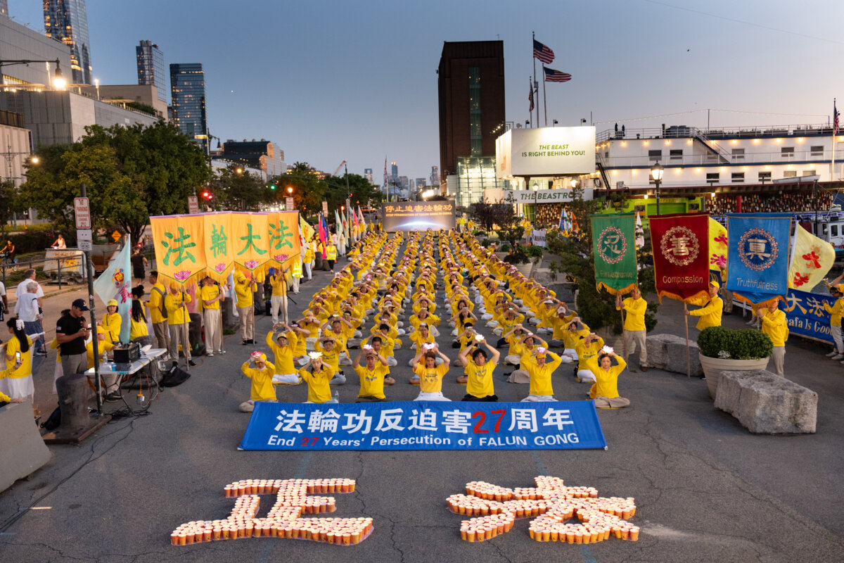 Falun Gong practitioners participate in a vigil in New York City to mark 27 years of the persecution of Falun Gong by the Chinese Communist Party in China on July 20, 2026. (Dai Bing/The Epoch Times)