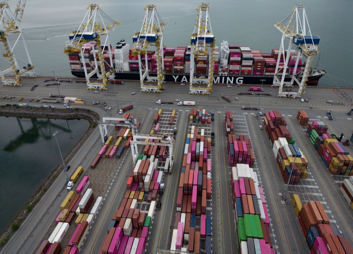 Containers are unloaded from the Yang Ming Throne container ship at Deltaport, at Roberts Bank in Delta, B.C., on July 16, 2026. (The Canadian Press/Darryl Dyck)