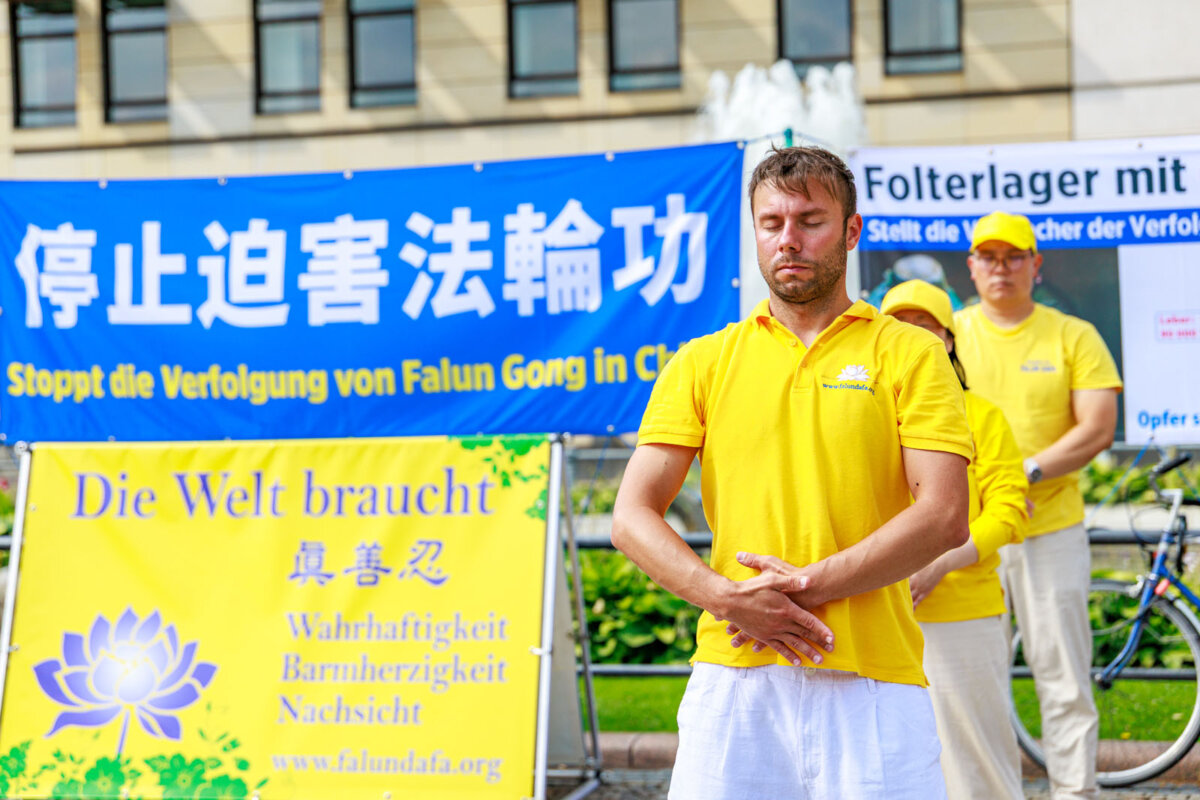Falun Gong practitioners gather at Berlin’s Brandenburg Gate on July 18, 2026, to raise awareness of the Chinese Communist Party’s persecution of the spiritual practice, which began in July 1999. (Courtesy of Minghui.org)