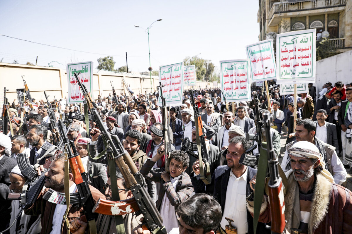 Houthi supporters hold up their weapons during a demonstration against the United States decision to designate the Houthis as a foreign terrorist organization, in Sanaa, Yemen, on Jan. 20, 2021. (Khaled Abdullah/Reuters)