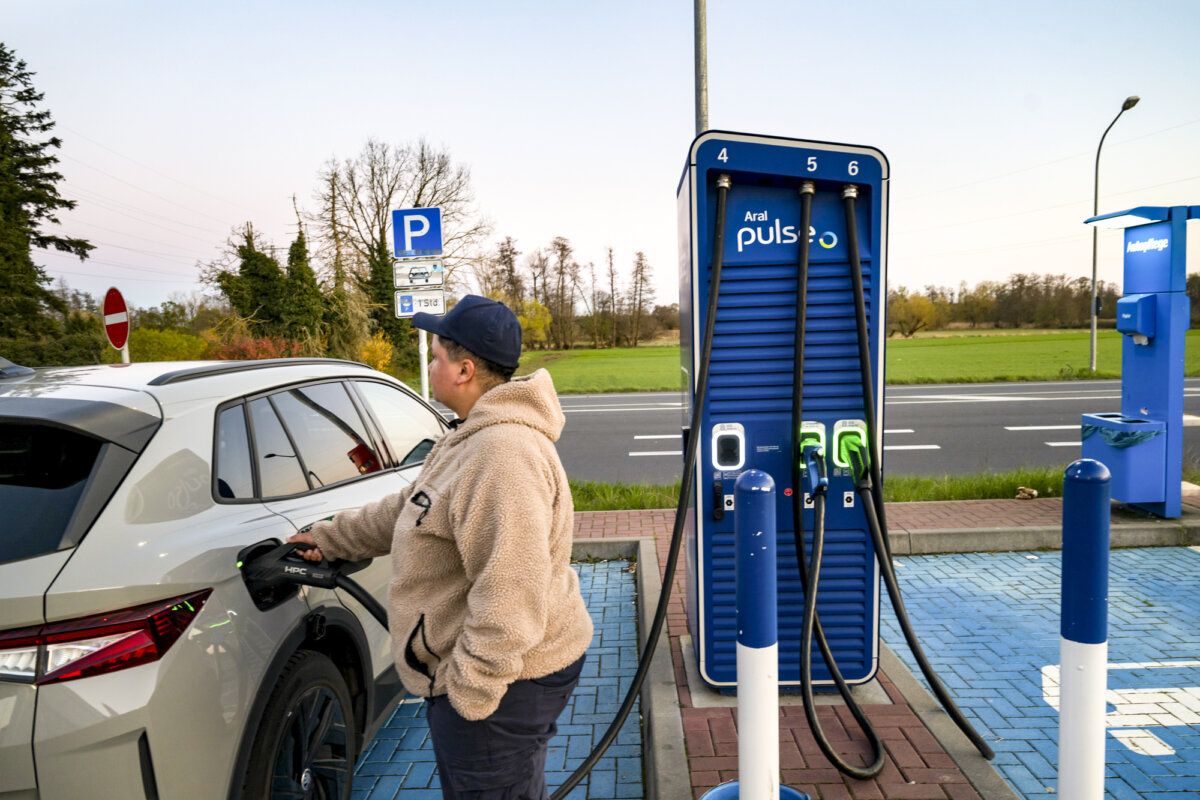 A driver charges an electric car at an Aral gas station in Moerfelden-Walldorf, Germany, on April 1, 2026. Electric vehicles tend to be more expensive to insure, largely because the battery—often the most costly single component—can account for up to 50 percent of the vehicle’s value. (Thomas Lohnes/Getty Images)