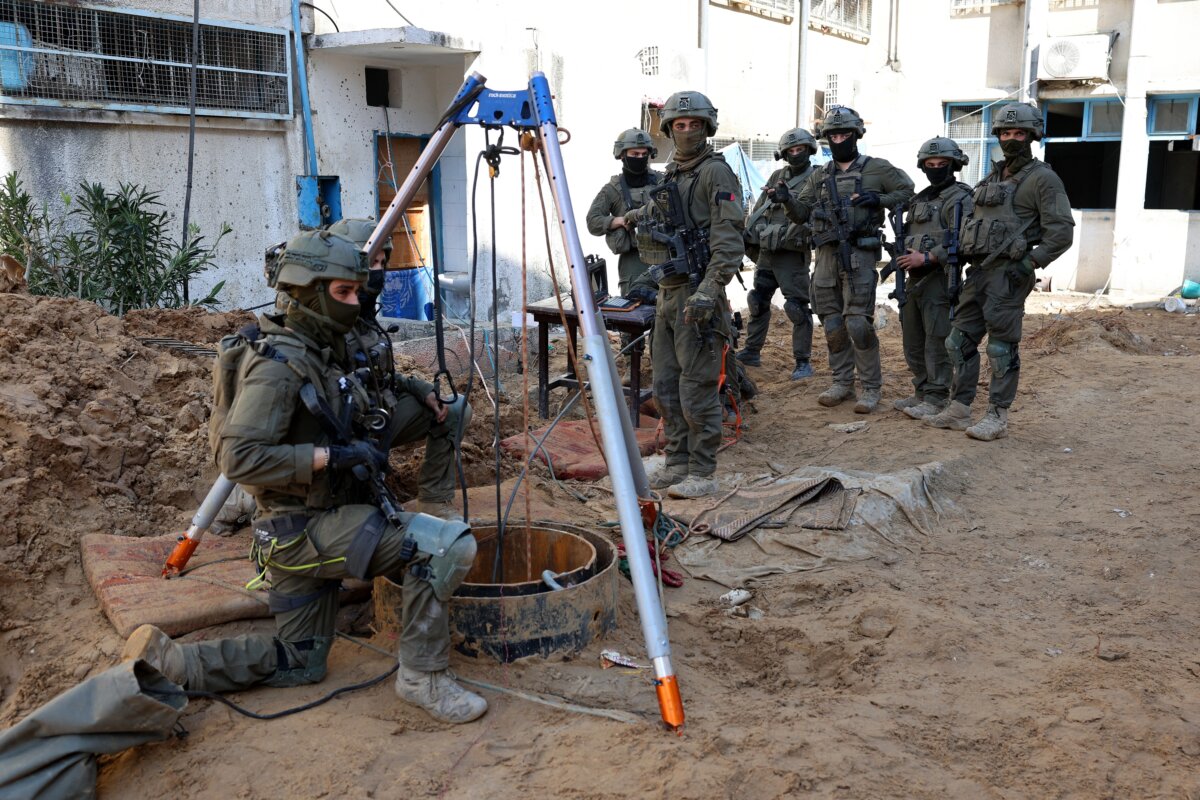 Israeli soldiers inspect the entrance to a Hamas terror tunnel directly outside an UNRWA compound in Gaza City on Feb. 8, 2024. (Jack Guez/AFP via Getty Images)