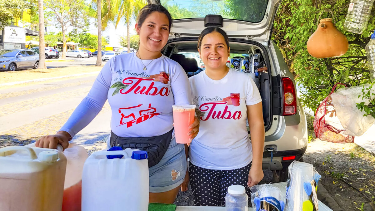 Sisters Amairani and Karla Bejarano, right, sell tuba on a street in Colima, Mexico. (Daniel Hernandez/Los Angeles Times/TNS)