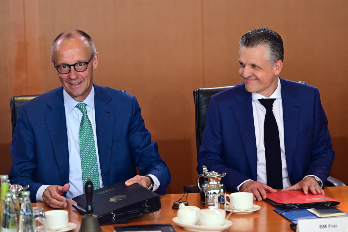 German Chancellor Friedrich Merz (L) and Thorsten Frei, head of the Federal Chancellery and federal minister for Special Tasks, attend a cabinet meeting at the chancellery in Berlin on July 22, 2026. (Sebastian Gollnow/dpa via AP)