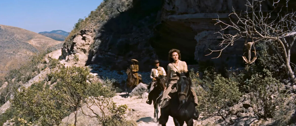 Leah Fuller (Susan Hayward) navigates a beautiful mountain pass, in “Garden of Evil.” (20th Century Fox)