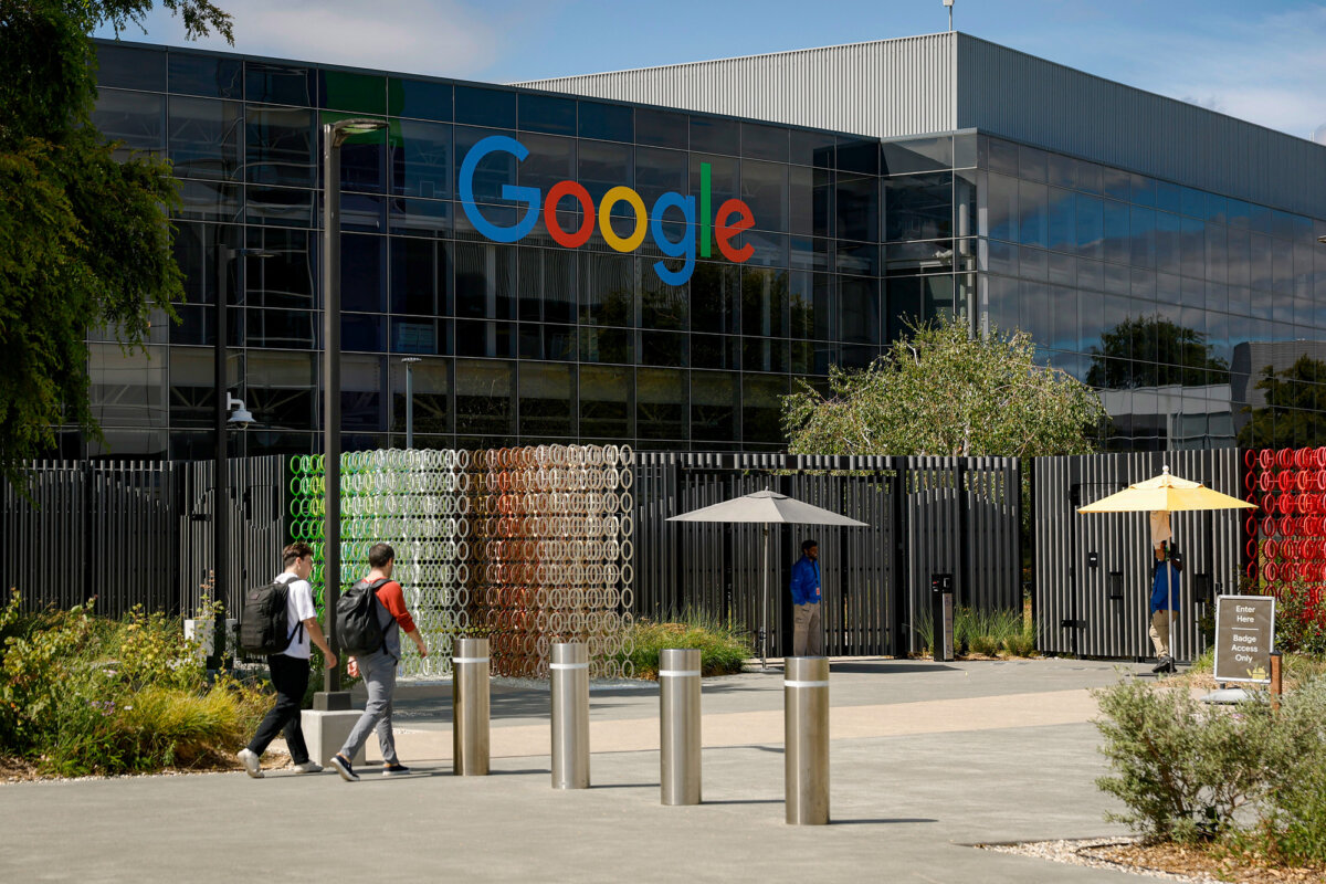 People pass a building on the Google headquarters campus in Mountain View, Calif., on July 23, 2025. (Justin Sullivan/Getty Images)