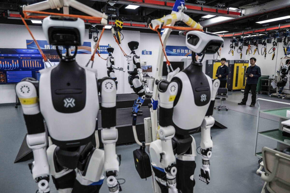 Engineers carry out testing on humanoid robots in the production facility of X-Humanoid at the Beijing Innovation Center of Humanoid Robotics in Beijing, China, on March 20, 2026. (Kevin Frayer/Getty Images)