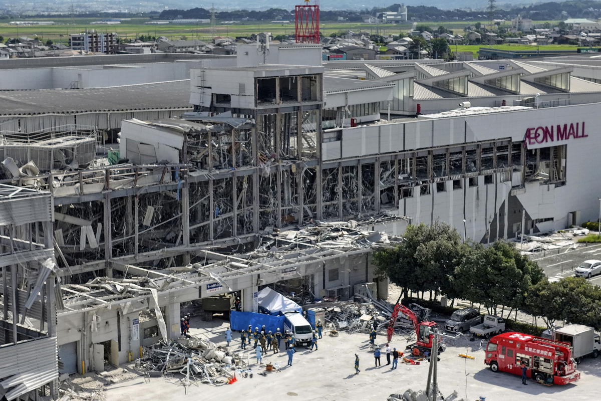 Responders work outside AEON Mall Kumamoto after an explosion occurred following an earthquake, in Kashima, Kumamoto Prefecture, southern Japan, on July 30, 2026. (Koji Harada/Kyodo News via AP)
