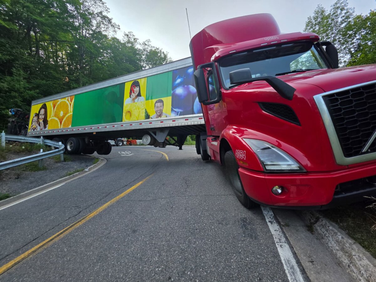 A Mississauga truck driver is facing two charges after getting wedged in a ‘hairpin turn’ in Caledon, Ont., in the northwestern part of the Greater Toronto Area. (OPP/handout photo)