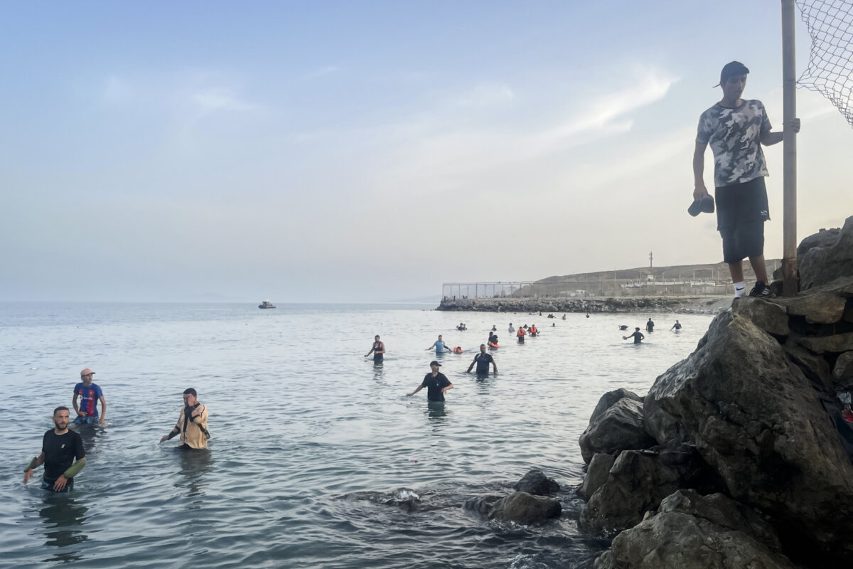 Moroccan migrants swim across the sea border into Ceuta, Spain, on July 31, 2026. (Etienne Fauchaire/ The Epoch Times)