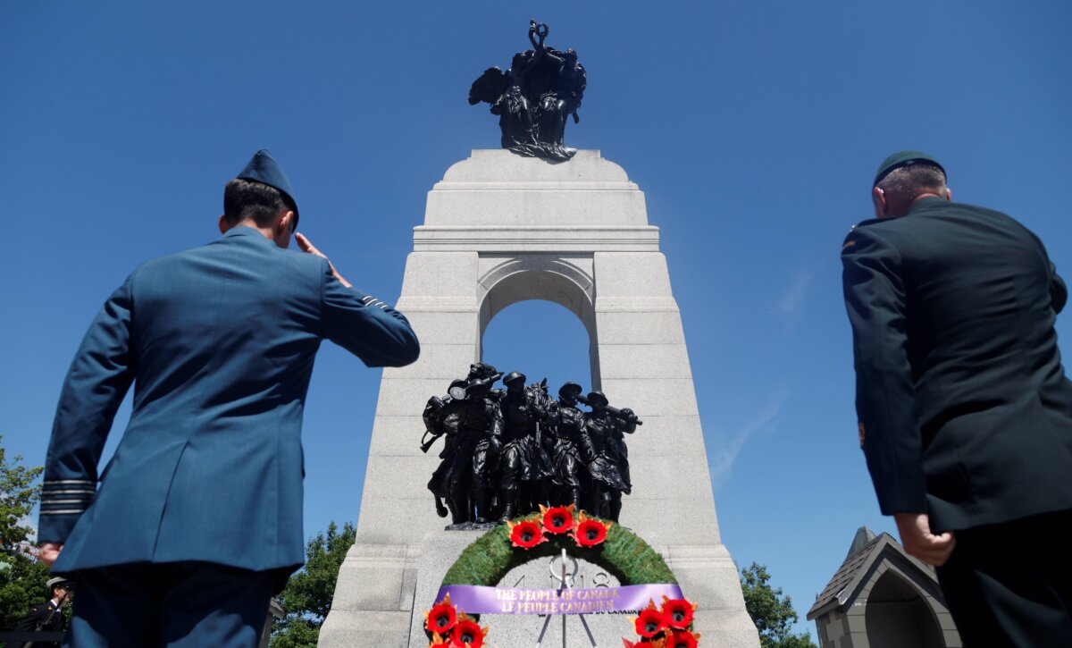 Members of the Canadian Armed Forces salute after a ceremony marking the 100th anniversary of the Royal Canadian Legion, at the National War Memorial in Ottawa on July 17, 2026. (The Canadian Press/Patrick Doyle)