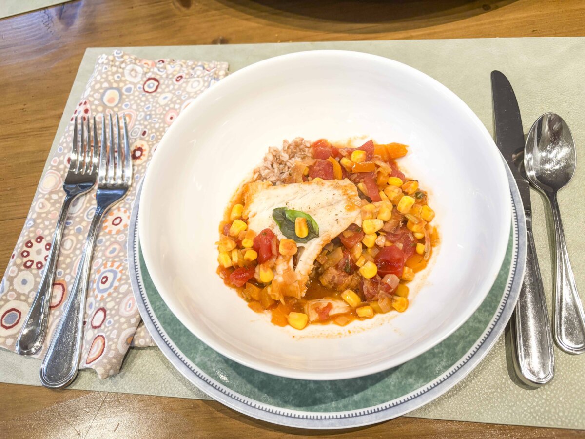 This saucy fish dish is brightened with tomatoes, corn, and sweet peppers. (Diane Rossen Worthington /TCA)