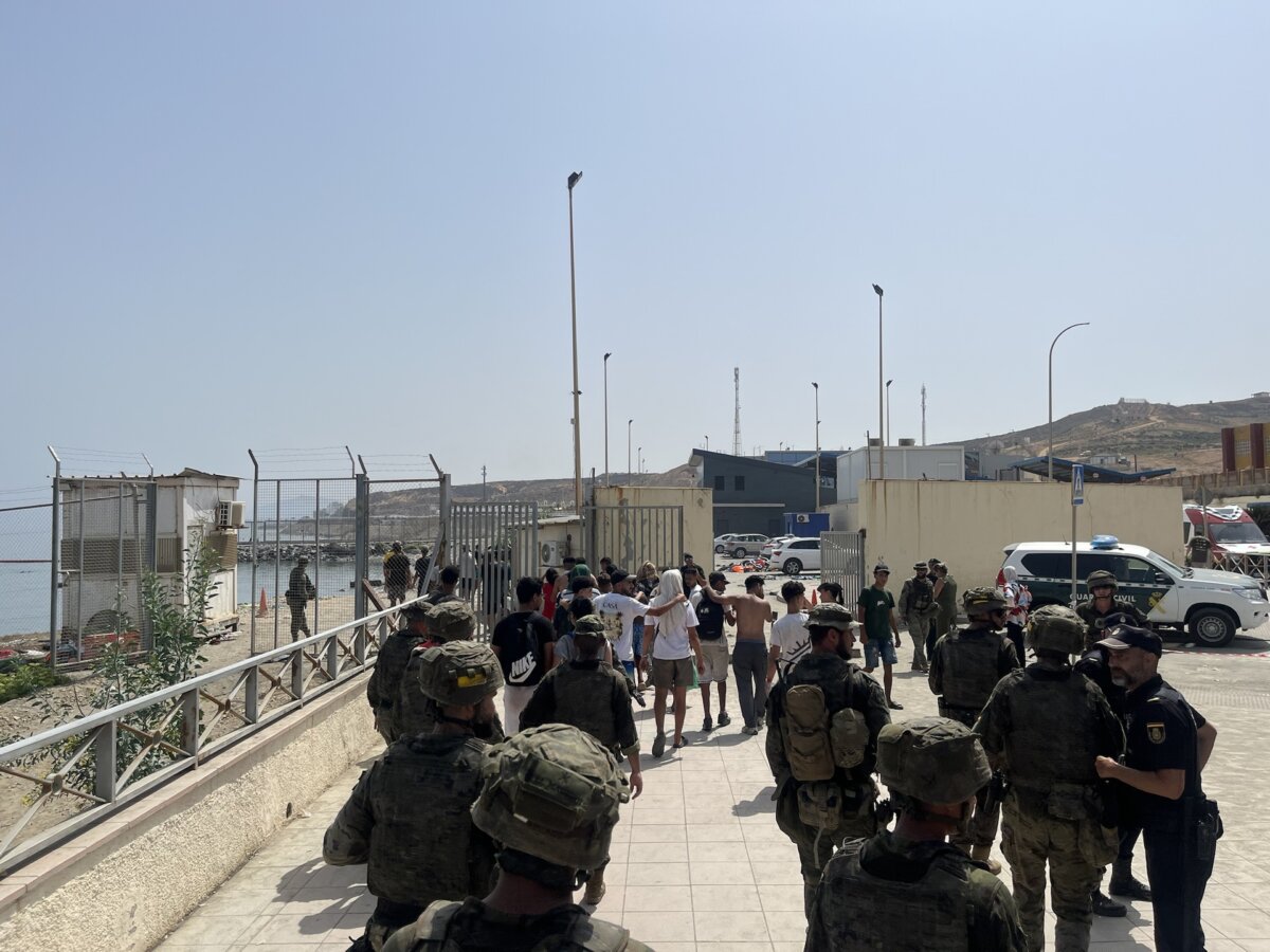 Spanish soldiers and Guardia Civil officers escort a group of young migrants back toward Morocco near the coastal border in Ceuta, Spain, on Aug. 1, 2026.
(Etienne Fauchaire/The Epoch Times)