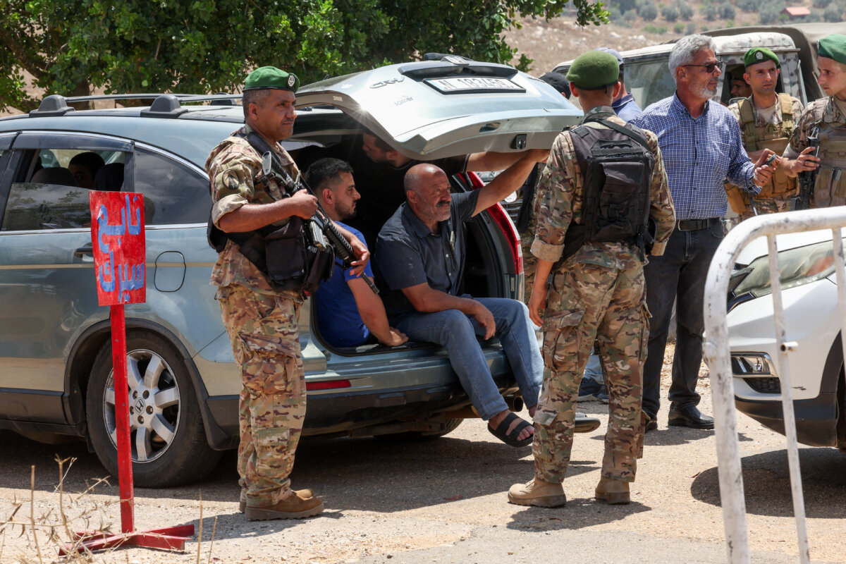Lebanese soldiers inspect vehicles as residents wait to enter the town of Zawtar al-Gharbiyeh, following the withdrawal of Israeli forces under a U.S.-brokered plan, in southern Lebanon, on July 24, 2026. (Aziz Taher/Reuters)