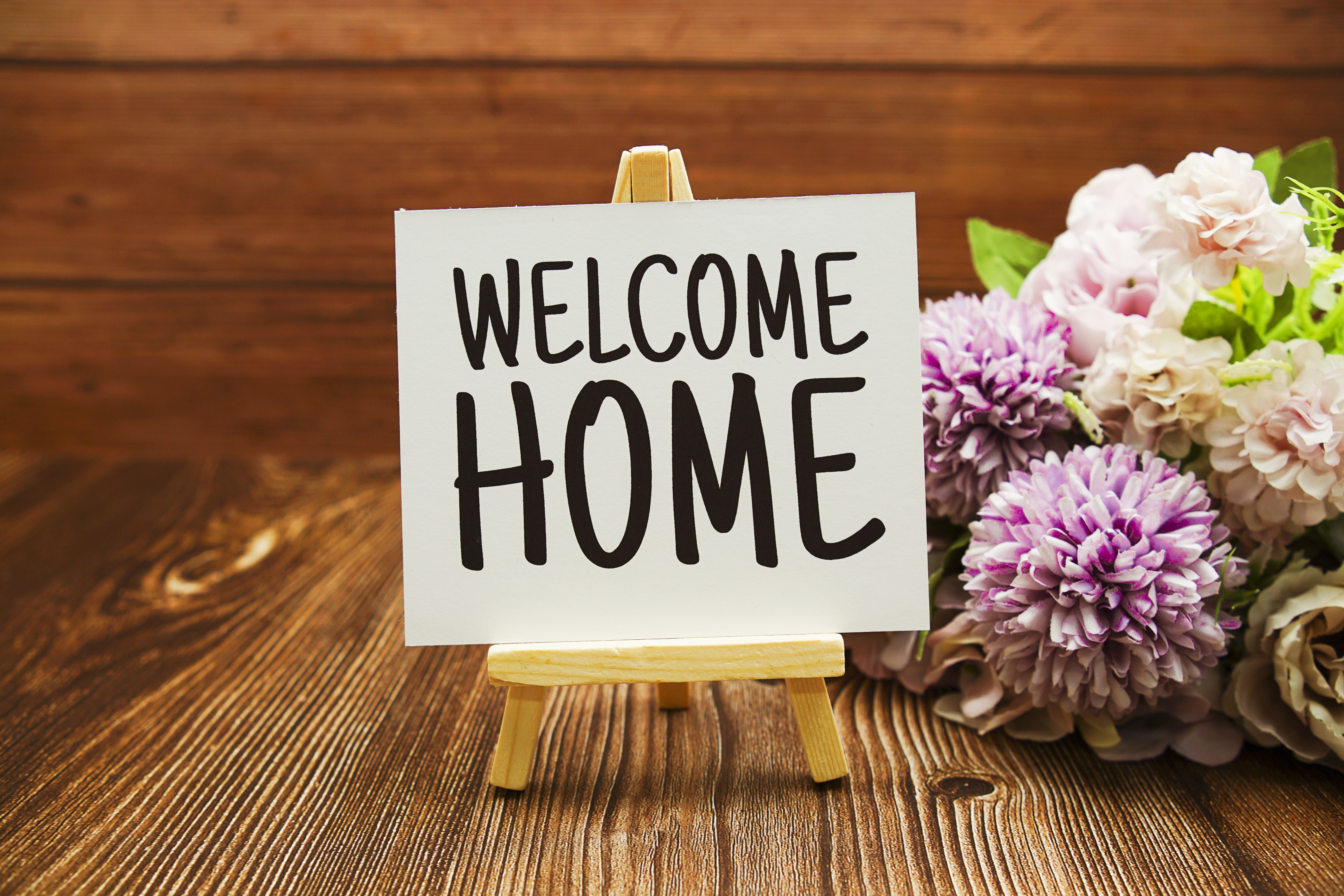 Welcome,Home,Text,On,Paper,Card,On,Wooden,Background