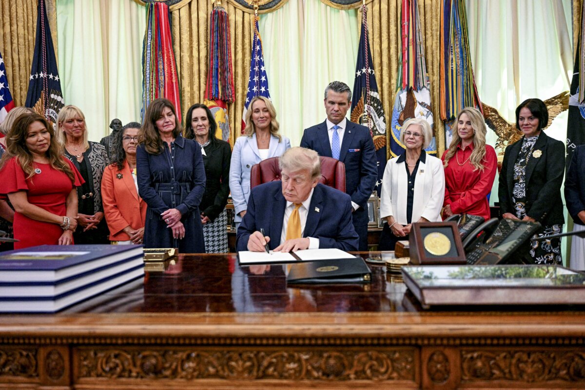 President Donald Trump displays an executive order he signed in the Oval Office of the White House on Aug. 3, 2026. (Jim Watson/AFP via Getty Images)